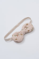 Avauma Petite Garden Baby Headband in Honey n’ Rose, with muted orange and pink floral print on soft peach background and beige elastic band